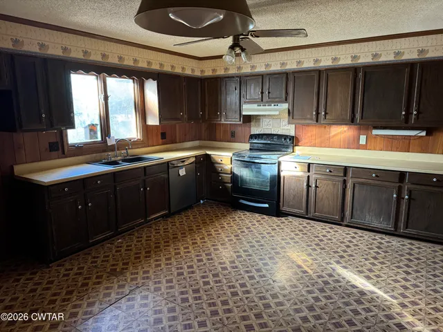 a kitchen with stainless steel appliances granite countertop a sink and cabinets