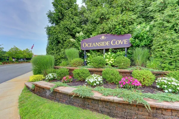 a sign that is sitting in front of flowers