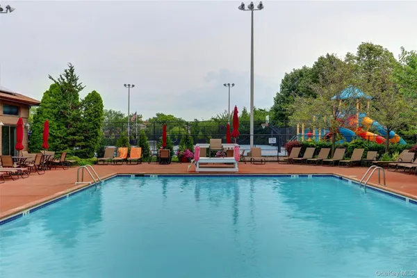 a kitchen with a refrigerator and white cabinets