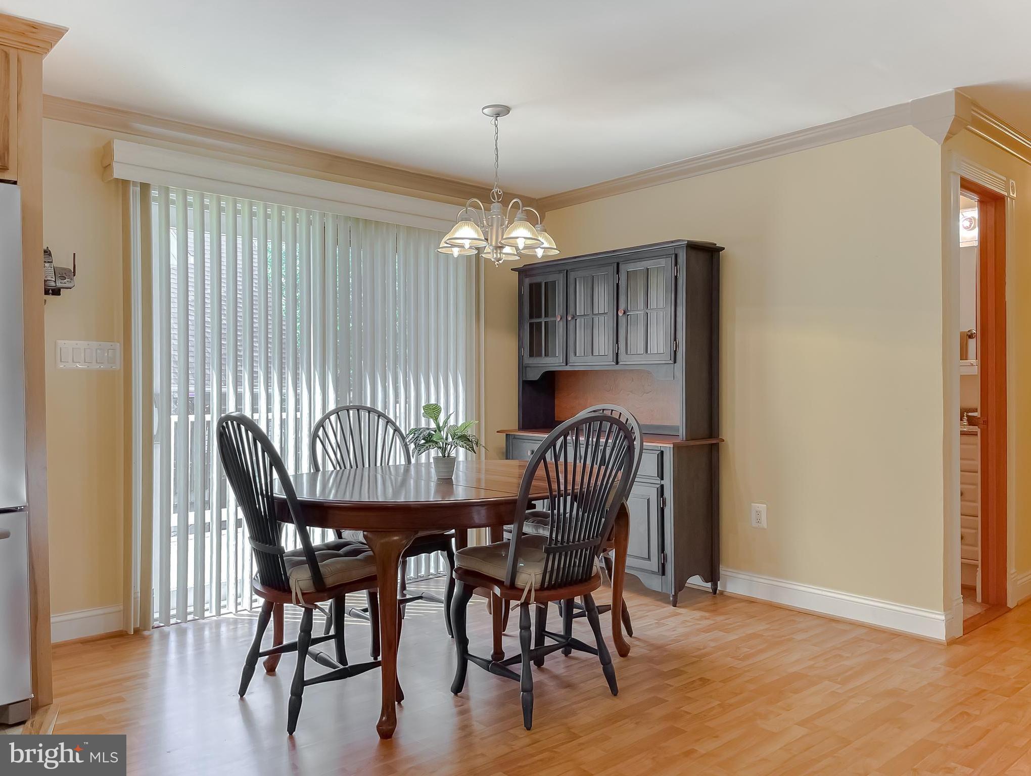 239 Frontier Trail Lusby, MD 20657 - Photo 13 of 73 Dining room with sliders to the wrap around deck