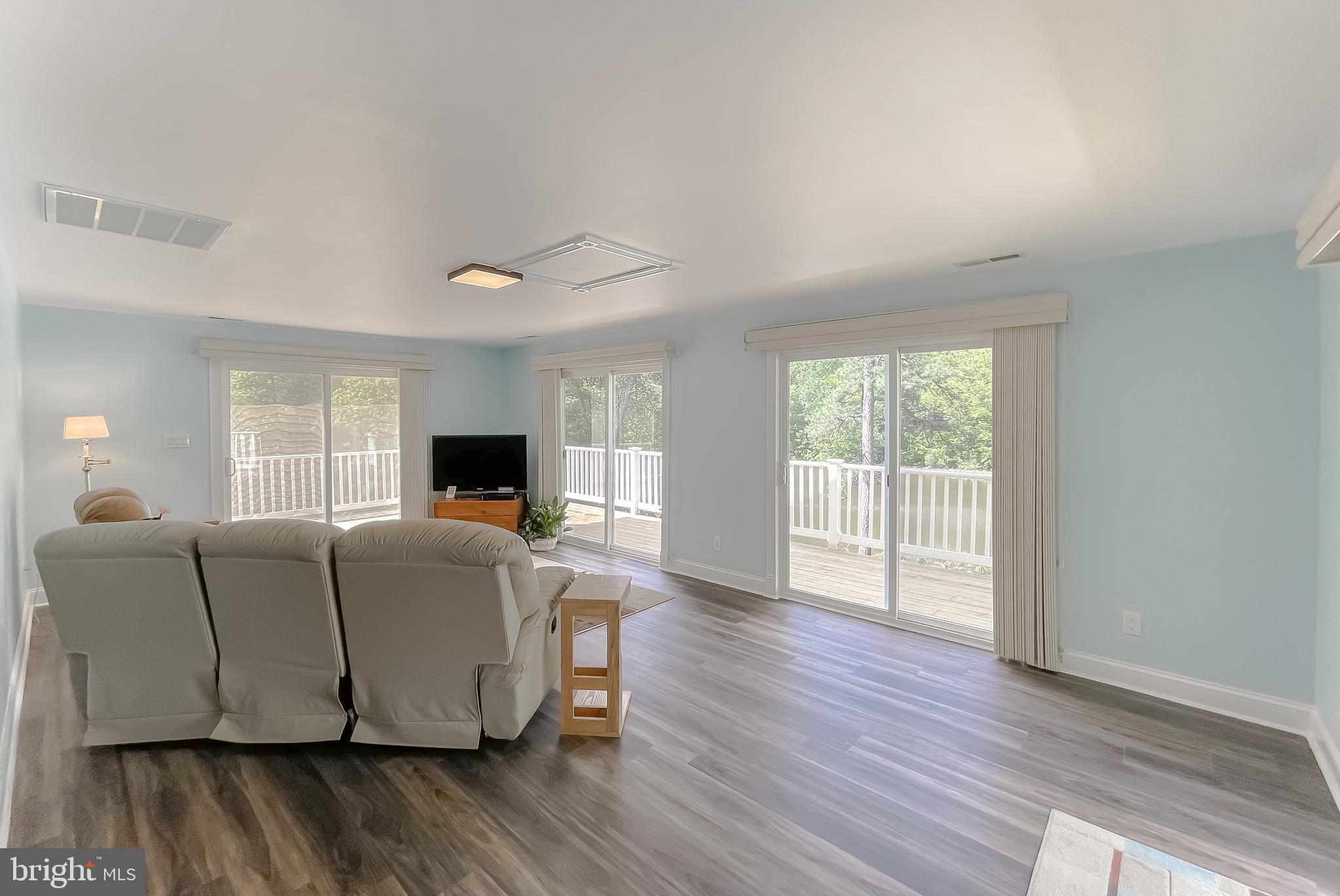 239 Frontier Trail Lusby, MD 20657 - Photo 24 of 73 Sunroom is bright & airy with sliders on 3-sides