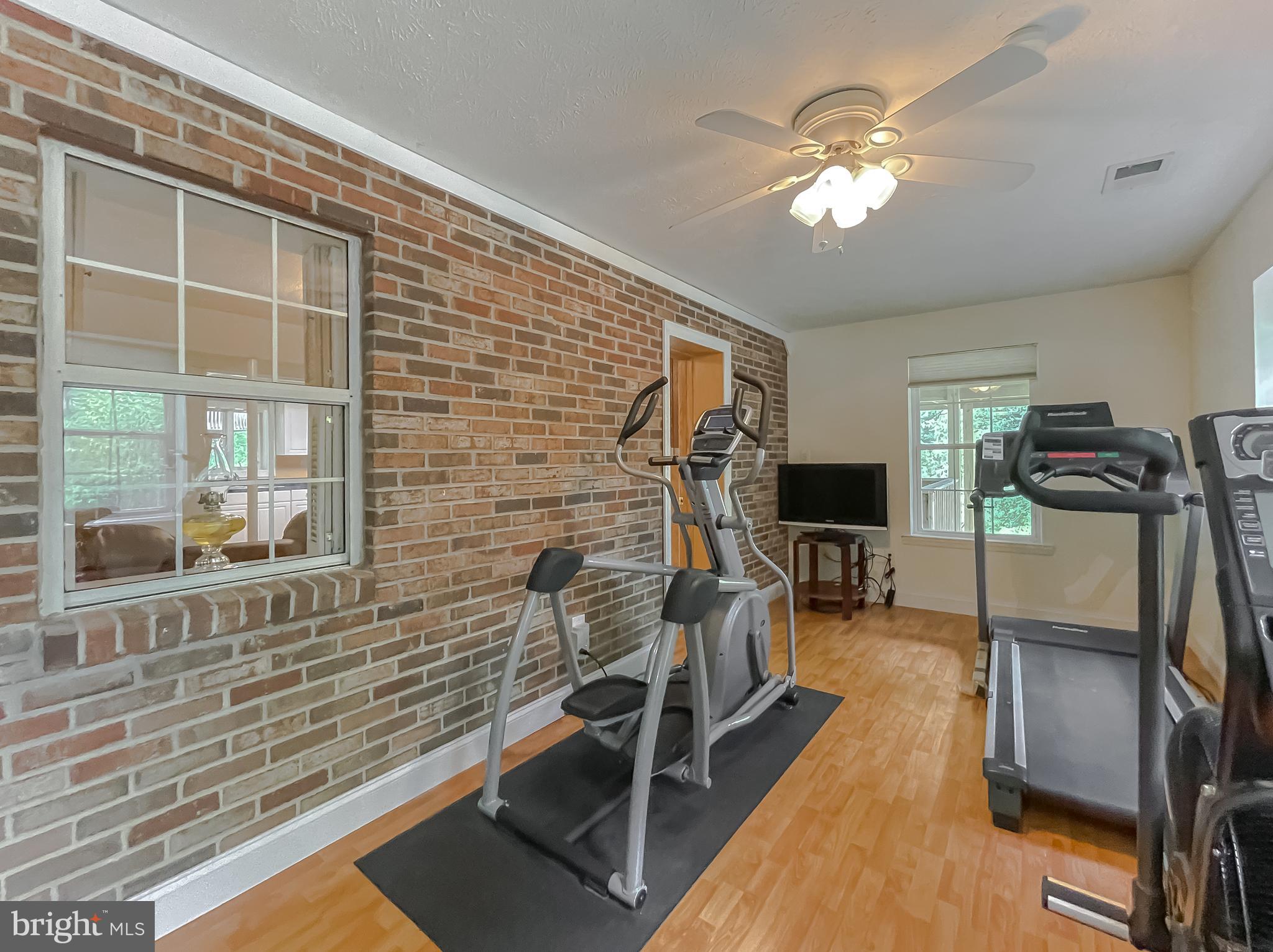 239 Frontier Trail Lusby, MD 20657 - Photo 42 of 73 3rd bedroom with exposed brick and water views
