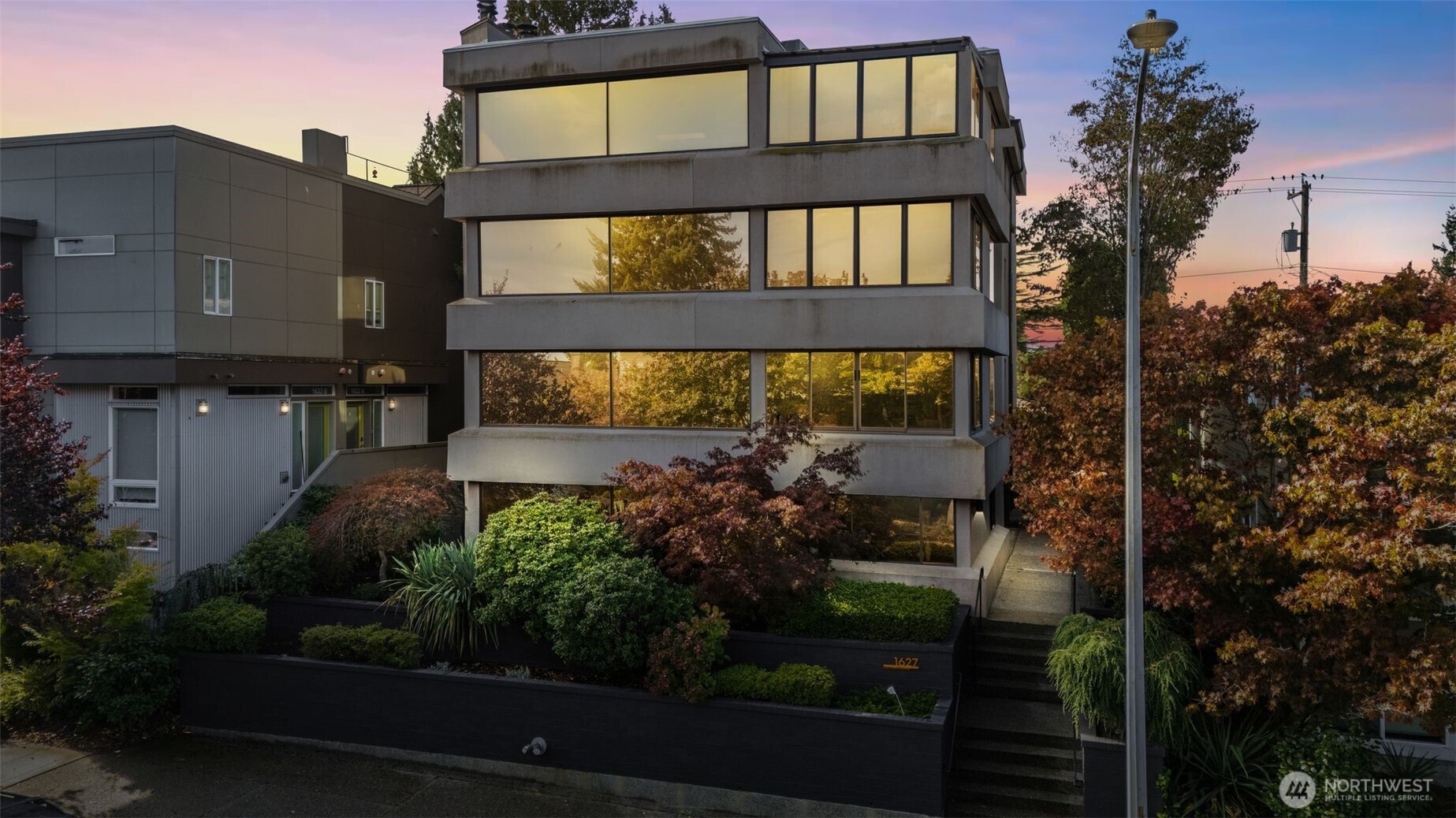 1627 California Avenue Southwest, Unit 1 Seattle, WA 98116 - Photo 1 of 24 a front view of a house with a yard