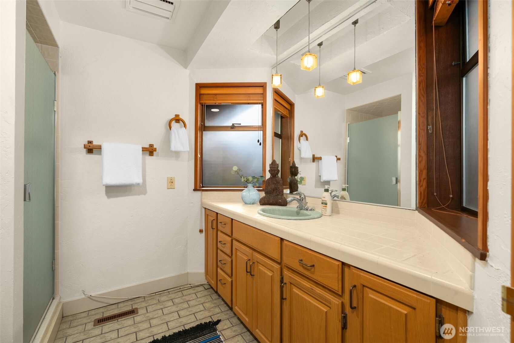 1627 California Avenue Southwest, Unit 1 Seattle, WA 98116 - Photo 13 of 24 a bathroom with a sink and a mirror
