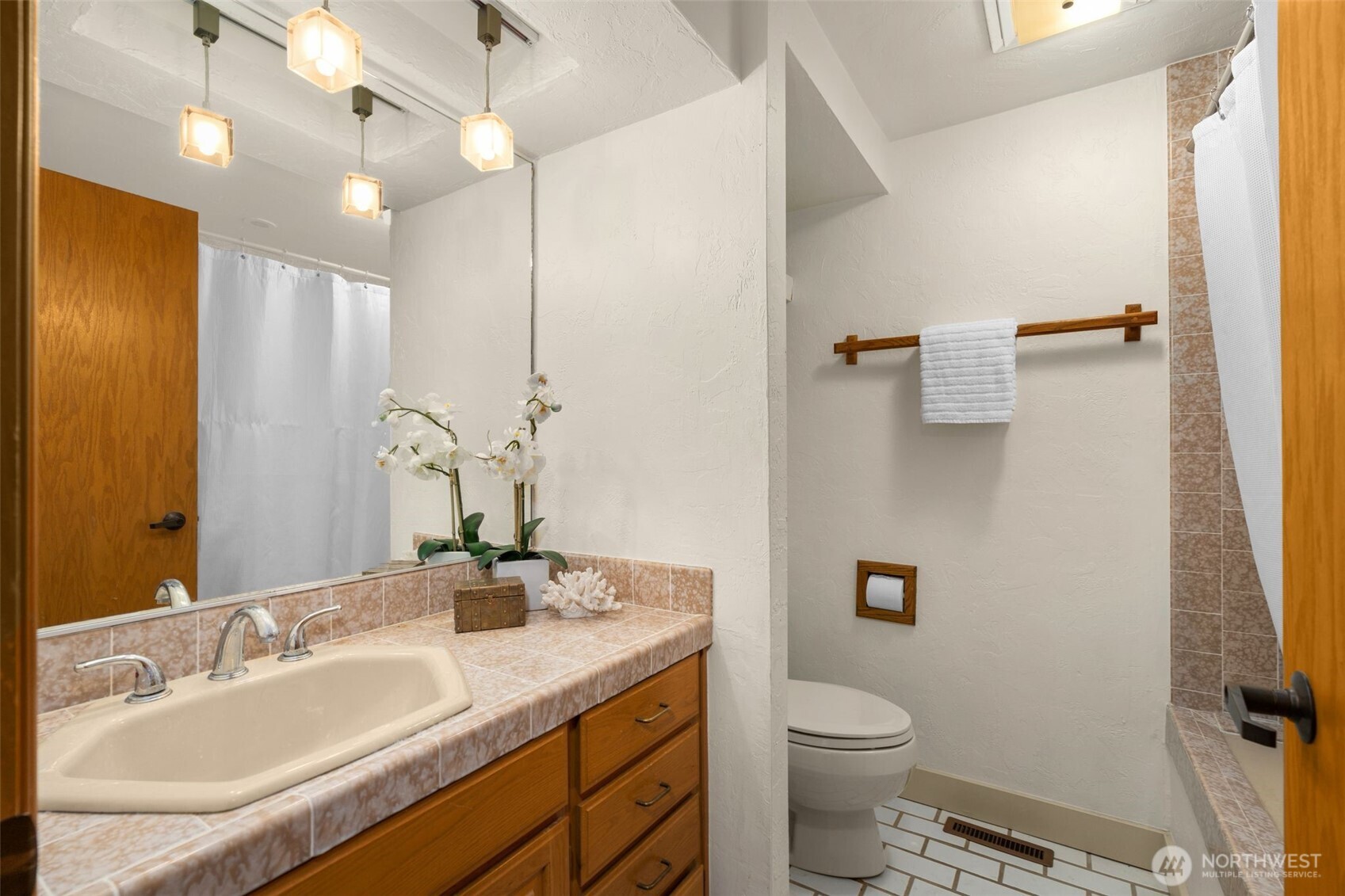 1627 California Avenue Southwest, Unit 1 Seattle, WA 98116 - Photo 16 of 24 a bathroom with a granite countertop sink toilet and a mirror