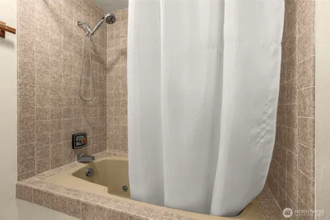 a bathroom with a bathtub and shower