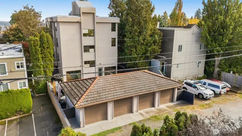 a view of a balcony with chairs and iron fence