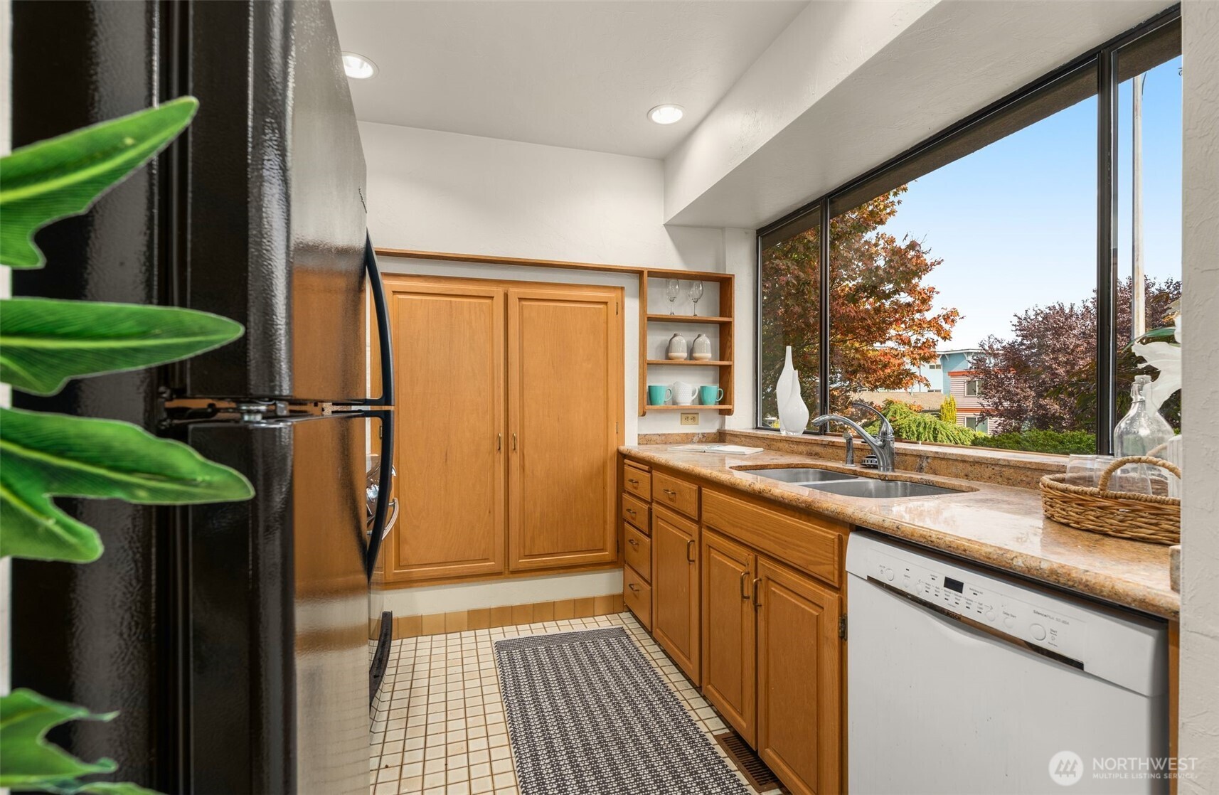 1627 California Avenue Southwest, Unit 1 Seattle, WA 98116 - Photo 9 of 24 a kitchen with stainless steel appliances granite countertop a refrigerator a sink and a cabinets