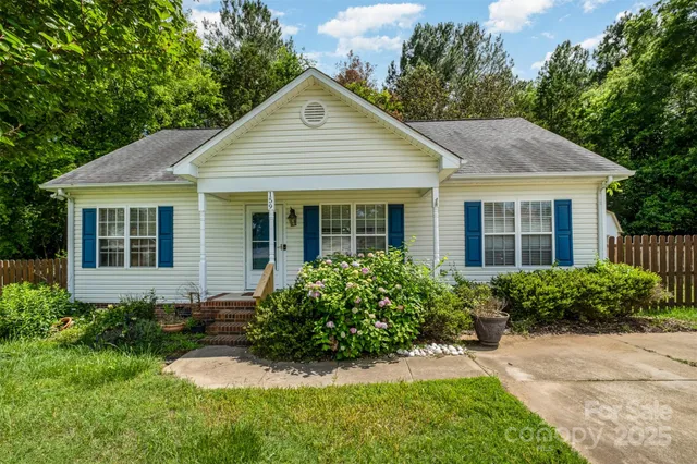 a front view of a house with a yard and porch