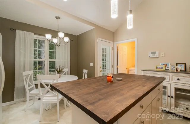a room with pool table and windows