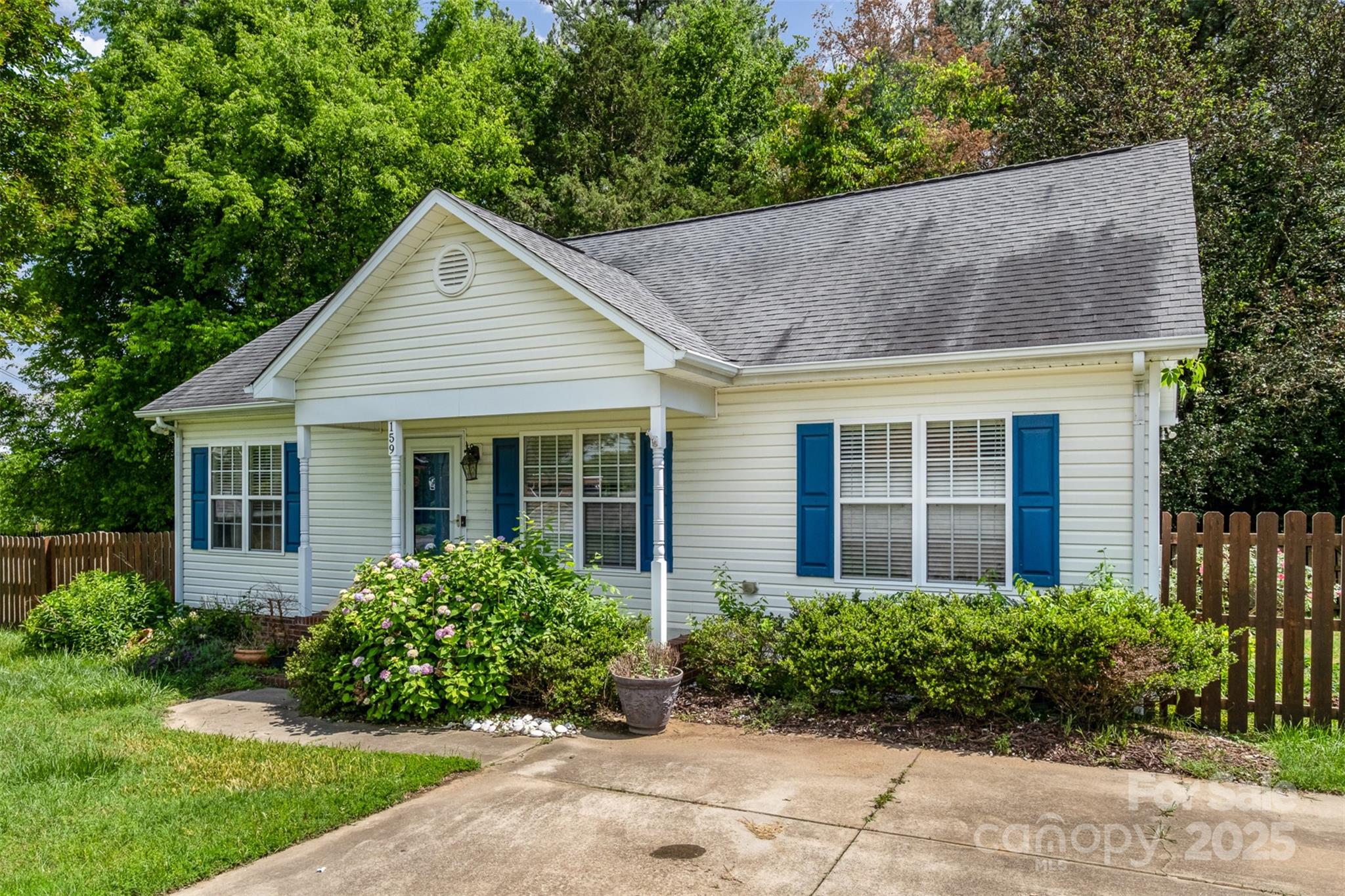 159 Pitts School Road Northwest Concord, NC 28027 - Photo 27 of 31 a view of a brick house with a large windows plants and large trees