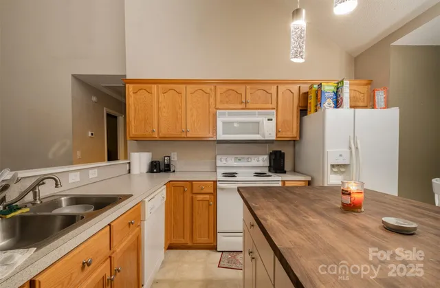 a kitchen with a sink a stove and cabinets