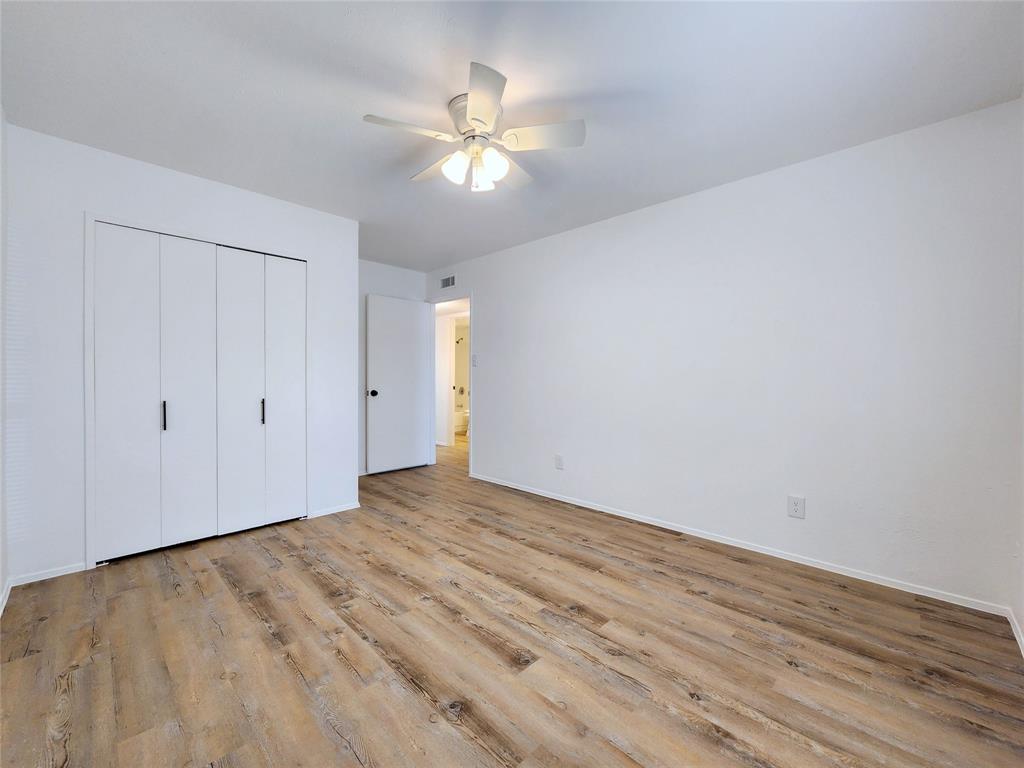 5541 Ragan Drive The Colony, TX 75056 - Photo 13 of 23 a view of an empty room with wooden floor