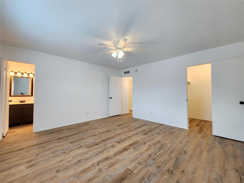 5541 Ragan Drive The Colony, TX 75056 - Photo 16 of 23 a view of a big room with wooden floor and a kitchen