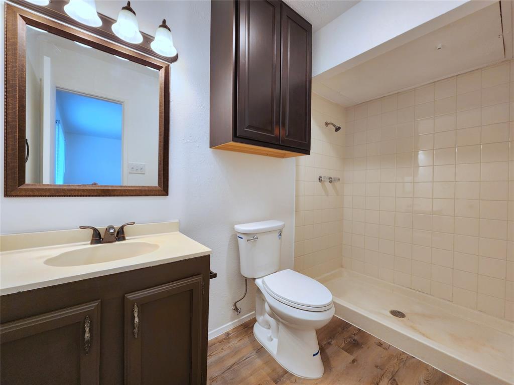 5541 Ragan Drive The Colony, TX 75056 - Photo 19 of 23 a bathroom with a sink a toilet and shower