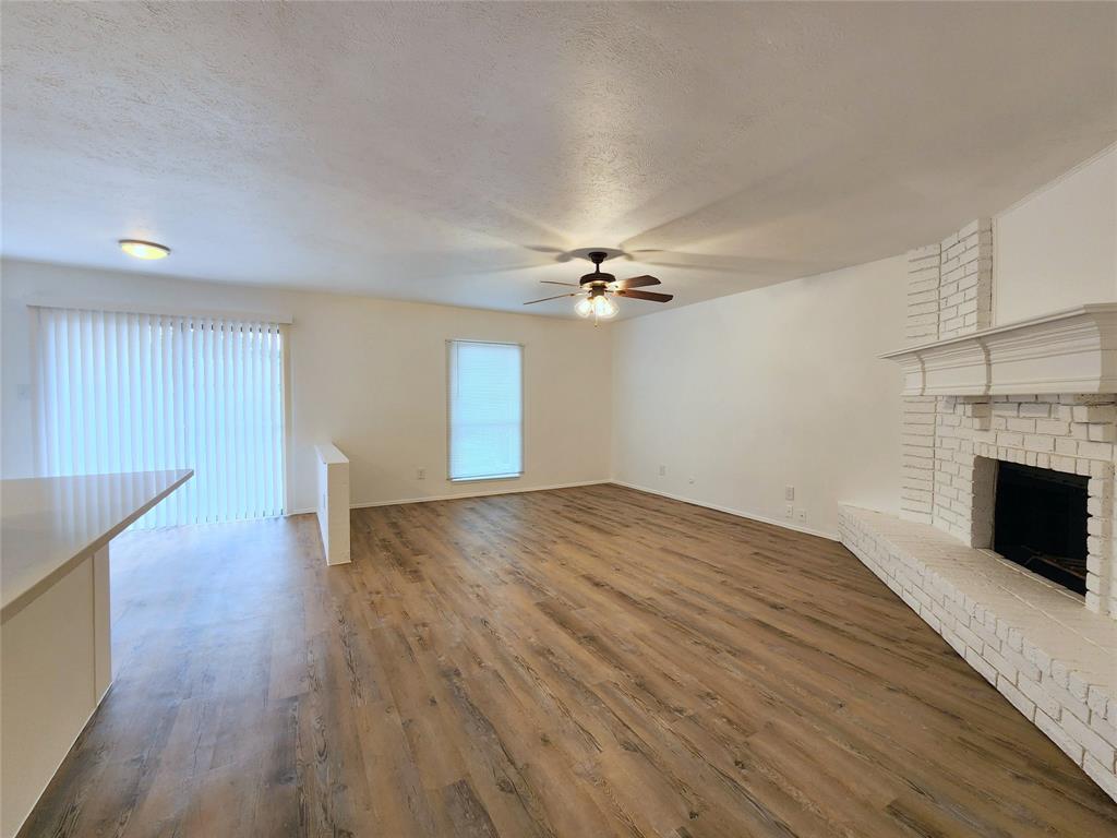 5541 Ragan Drive The Colony, TX 75056 - Photo 4 of 23 a view of empty room with wooden floor and fireplace