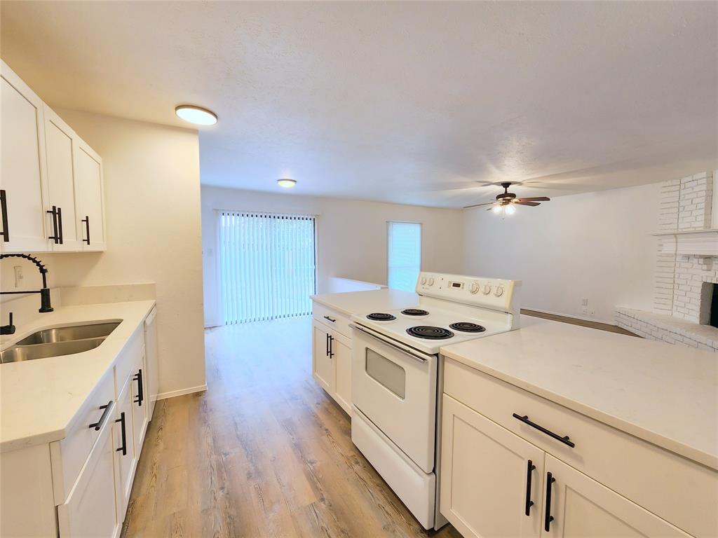 5541 Ragan Drive The Colony, TX 75056 - Photo 7 of 23 a kitchen with a sink stove and cabinets