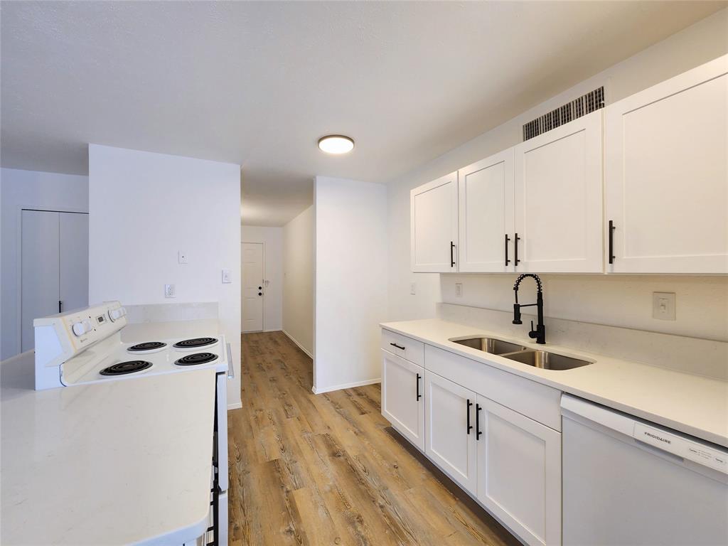 5541 Ragan Drive The Colony, TX 75056 - Photo 8 of 23 a kitchen that has a sink and white cabinets