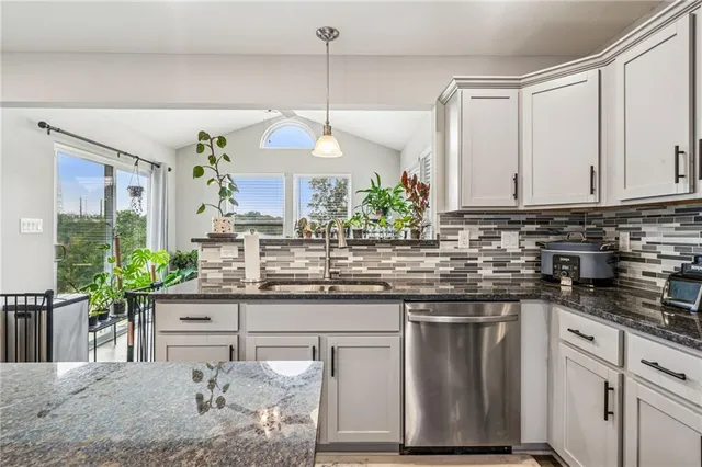 a kitchen with counter top space and a chandelier