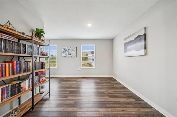 a view of room with window and book shelf