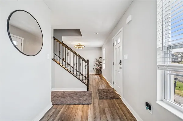 a view of an entryway with wooden floor