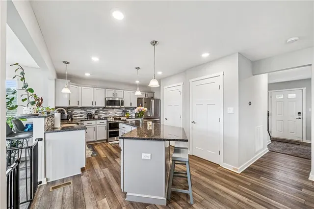 a kitchen with a sink refrigerator and cabinets