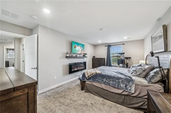 a spacious bedroom with a bed and furniture