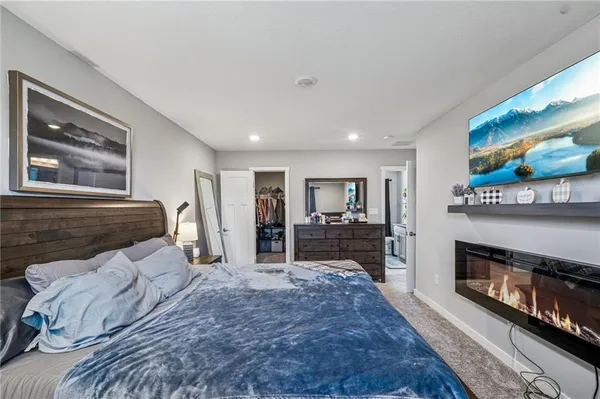 a bed room with a bed and a television