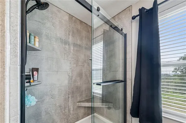 a bathroom with a glass door shower