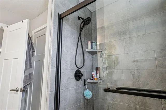 a bathroom with a glass door shower