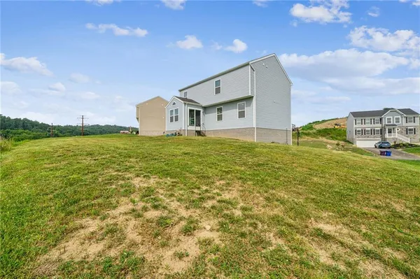 a house view with swimming pool in front of it