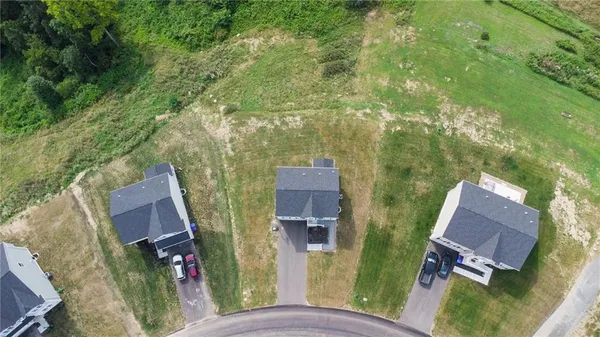an aerial view of a house with garden space and street view