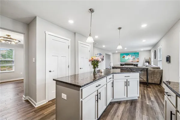 a kitchen with a sink refrigerator and cabinets