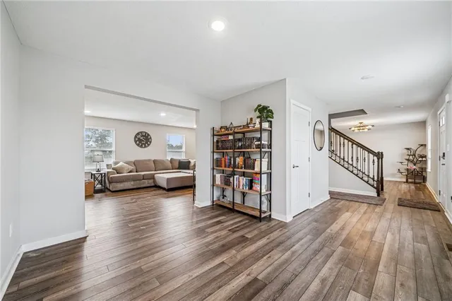 a view of room with window and book shelf