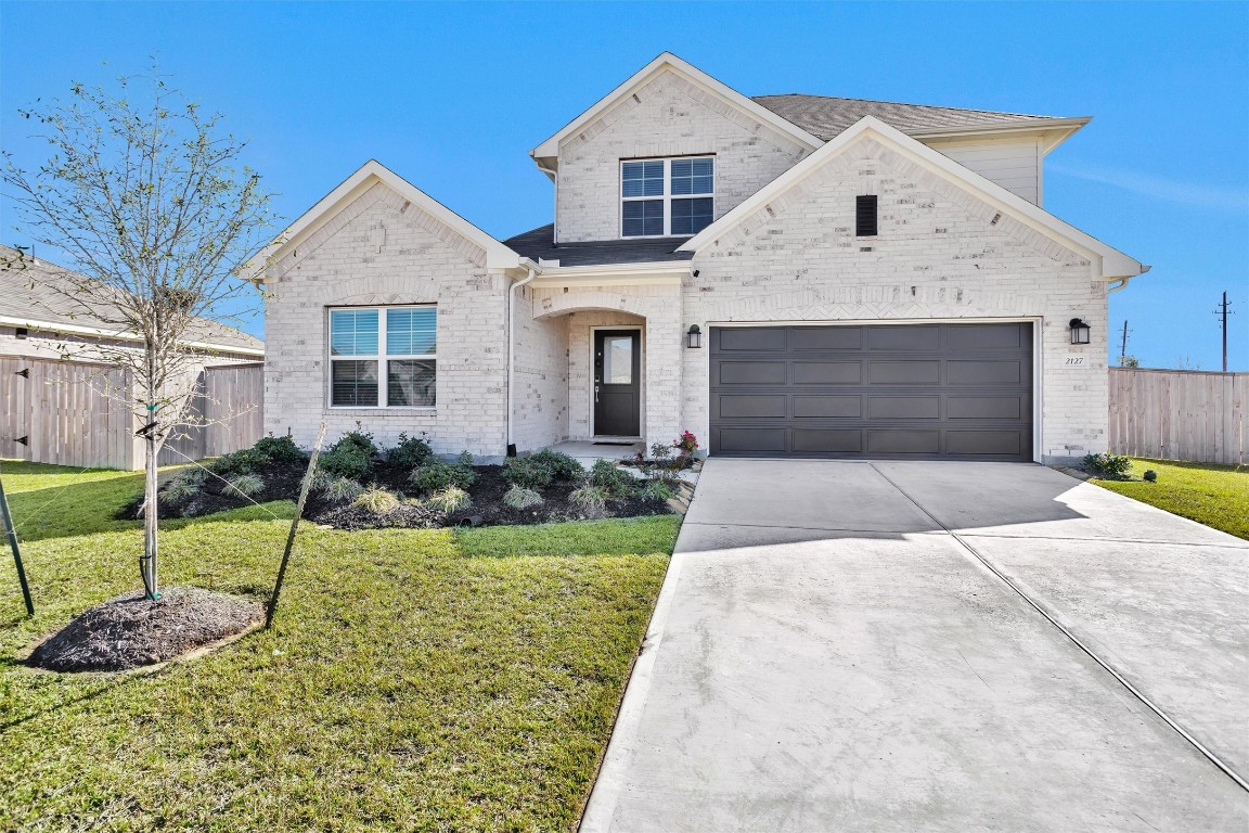 2127 Heather Rdg Way Rosenberg, TX 77471 - Photo 2 of 41 a front view of a house with a yard and garage