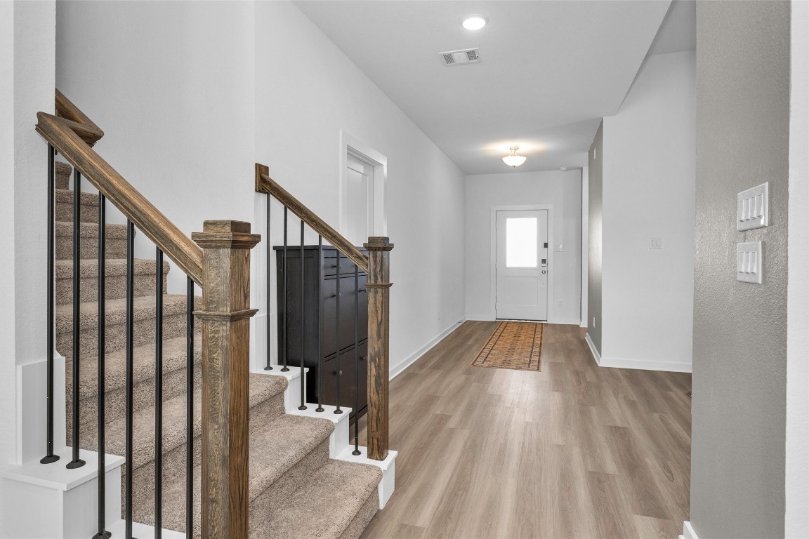 2127 Heather Rdg Way Rosenberg, TX 77471 - Photo 5 of 41 a view of hallway with wooden floor and stairs