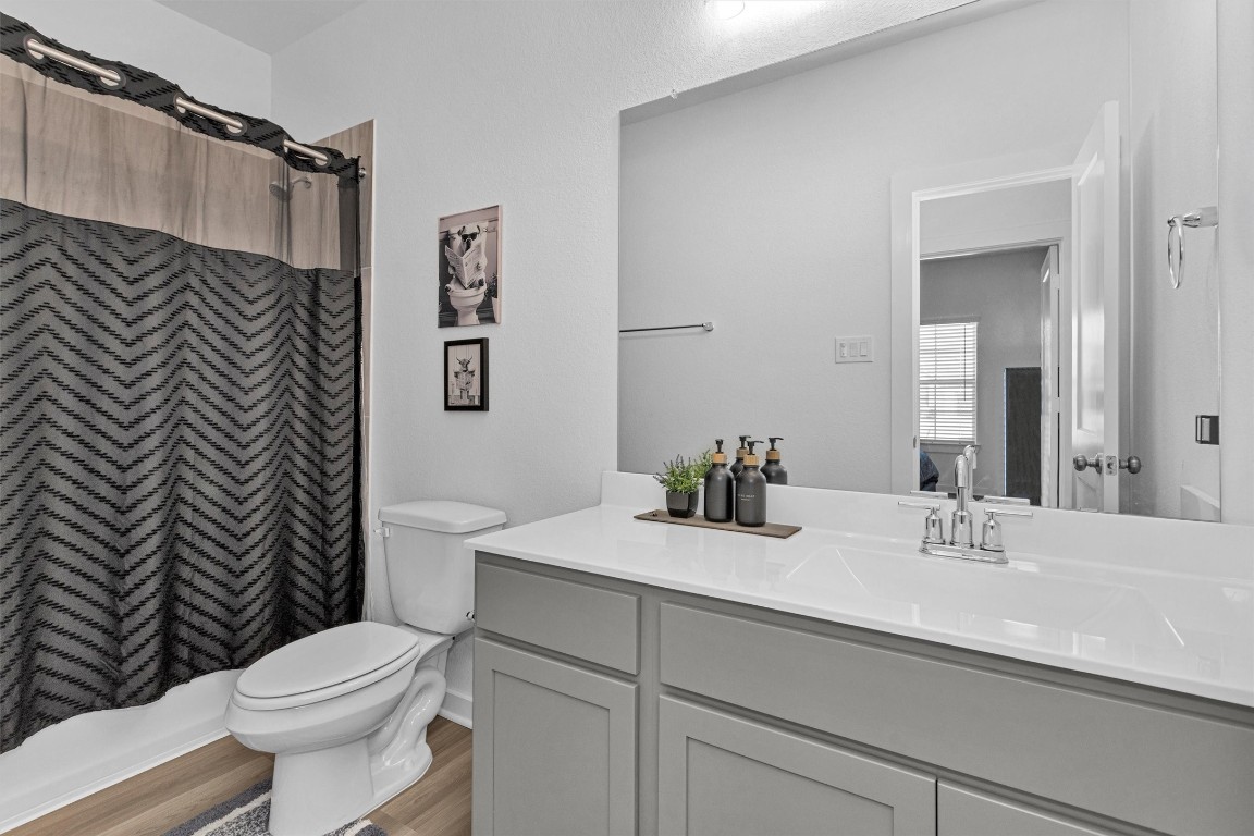 2127 Heather Rdg Way Rosenberg, TX 77471 - Photo 8 of 41 a bathroom with a sink a toilet a shower and a mirror