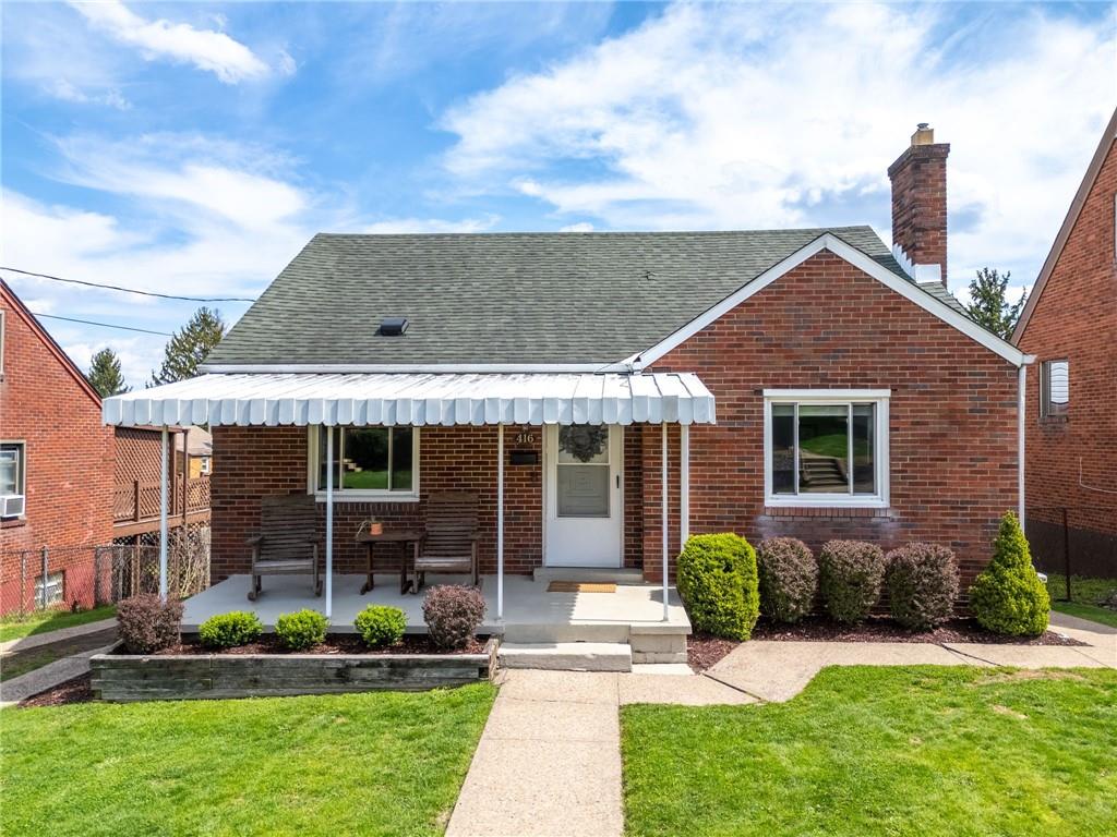 416 Phillips Avenue McKees Rocks, PA 15136 - Photo 2 of 46 a front view of a house with a yard and potted plants