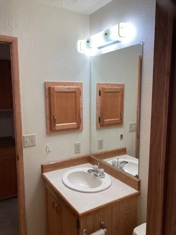 a kitchen with a table chairs refrigerator and cabinets