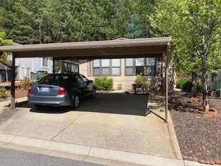 a kitchen with stainless steel appliances wooden floor and chairs