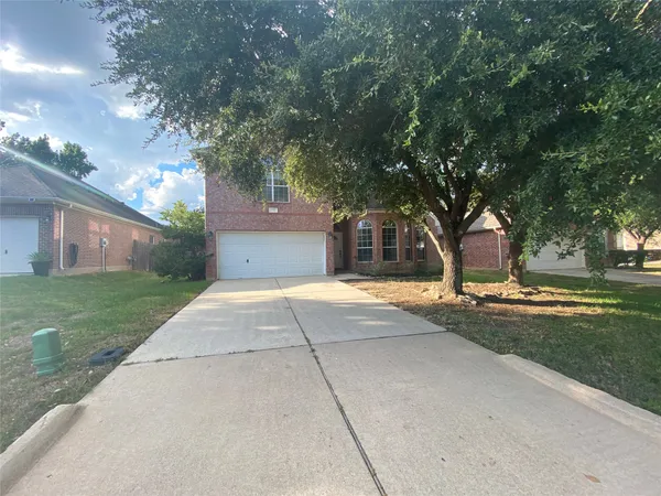a front view of a house with a yard and a garage