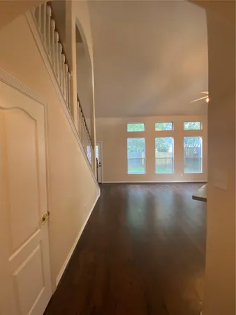 a view of entryway and hall with wooden floor