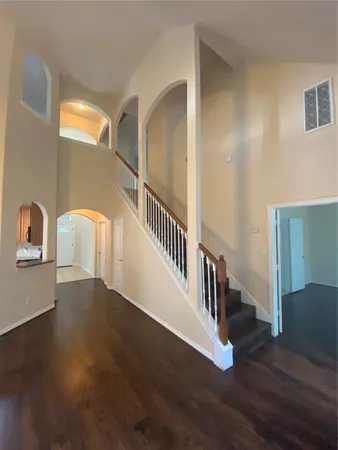 a dining room filled a chandelier and kitchen view