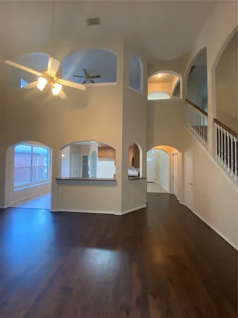 a kitchen with stainless steel appliances granite countertop a refrigerator a sink a stove and a wooden floors
