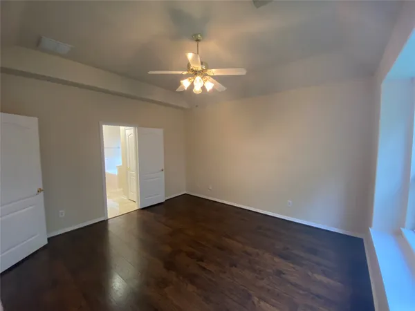 a view of stairs and utility room with windows