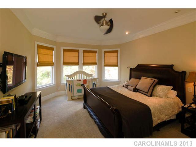 924 Ashford Way Fort Mill, SC 29708 - Photo 8 of 16 a bedroom with a bed and a flat tv screen on the dresser