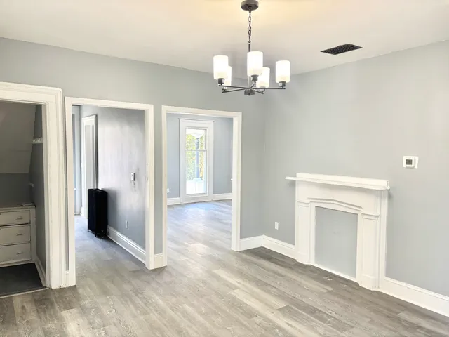 a view of a livingroom with a chandelier and entryway