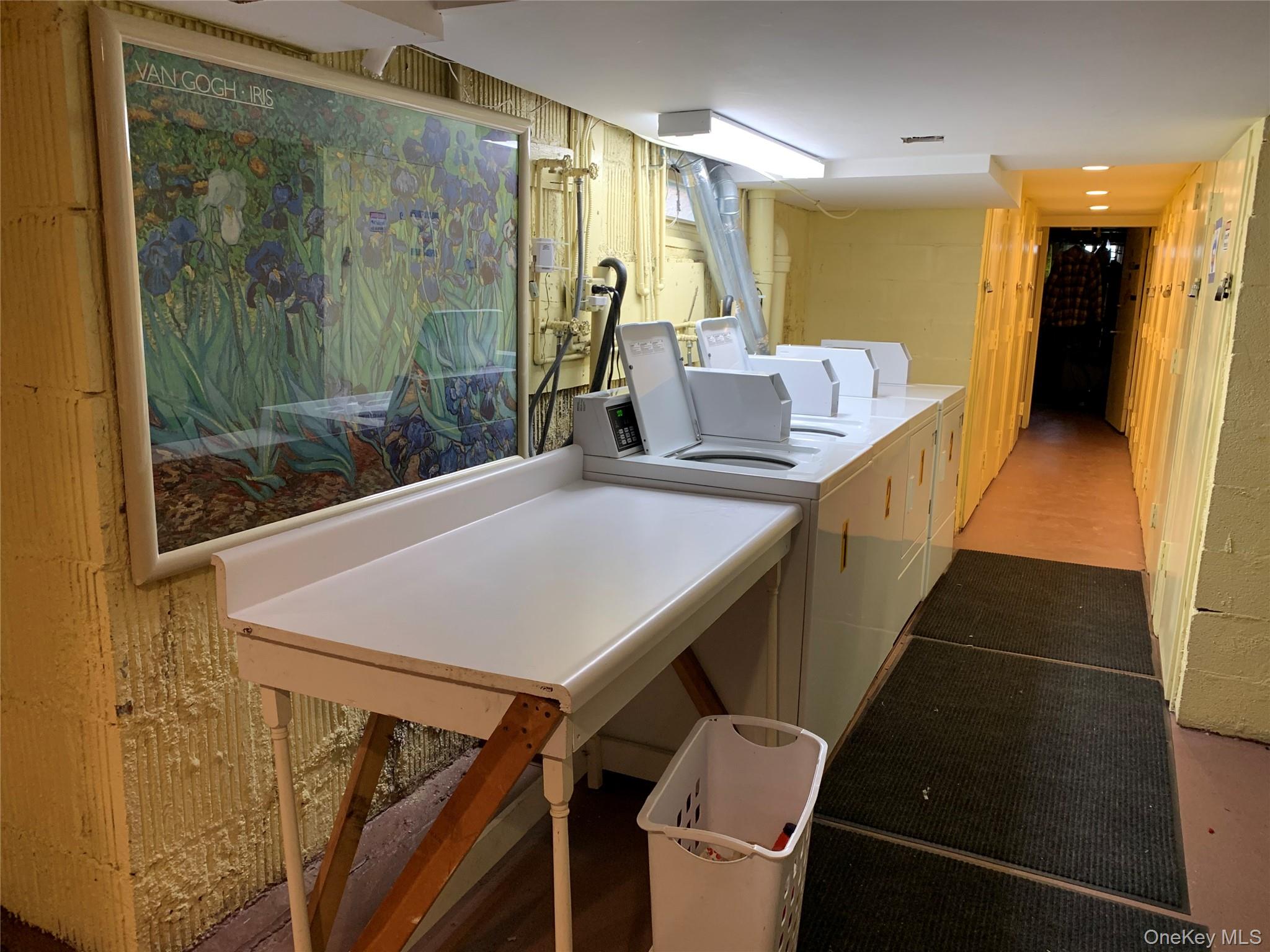 51 Smith Street, Unit B5 Merrick, NY 11566 - Photo 3 of 8 a view of a dining room with furniture and a chandelier