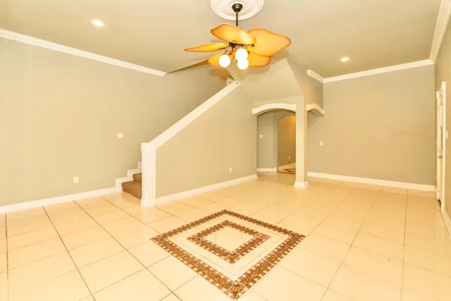 a view of a big room with wooden floor and windows