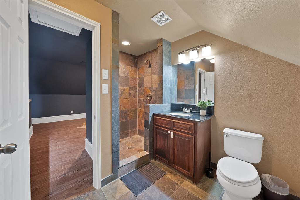 1110 McCampbell Road Mansfield, TX 76063 - Photo 35 of 39 a bathroom with a toilet a sink and glass door